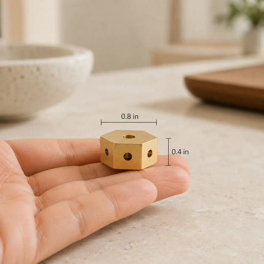 Lhasa Remedy mini brass hexagonal incense holder 0.8 inch wide 0.4 inch tall held in hand