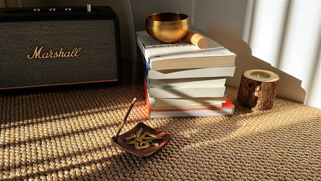 Chomolung Snow Tibetan incense stick burning in the Sacred OM Ceramic Incense Holder, surrounded by books, a singing bowl, and morning sunlight — a calm ritual space.