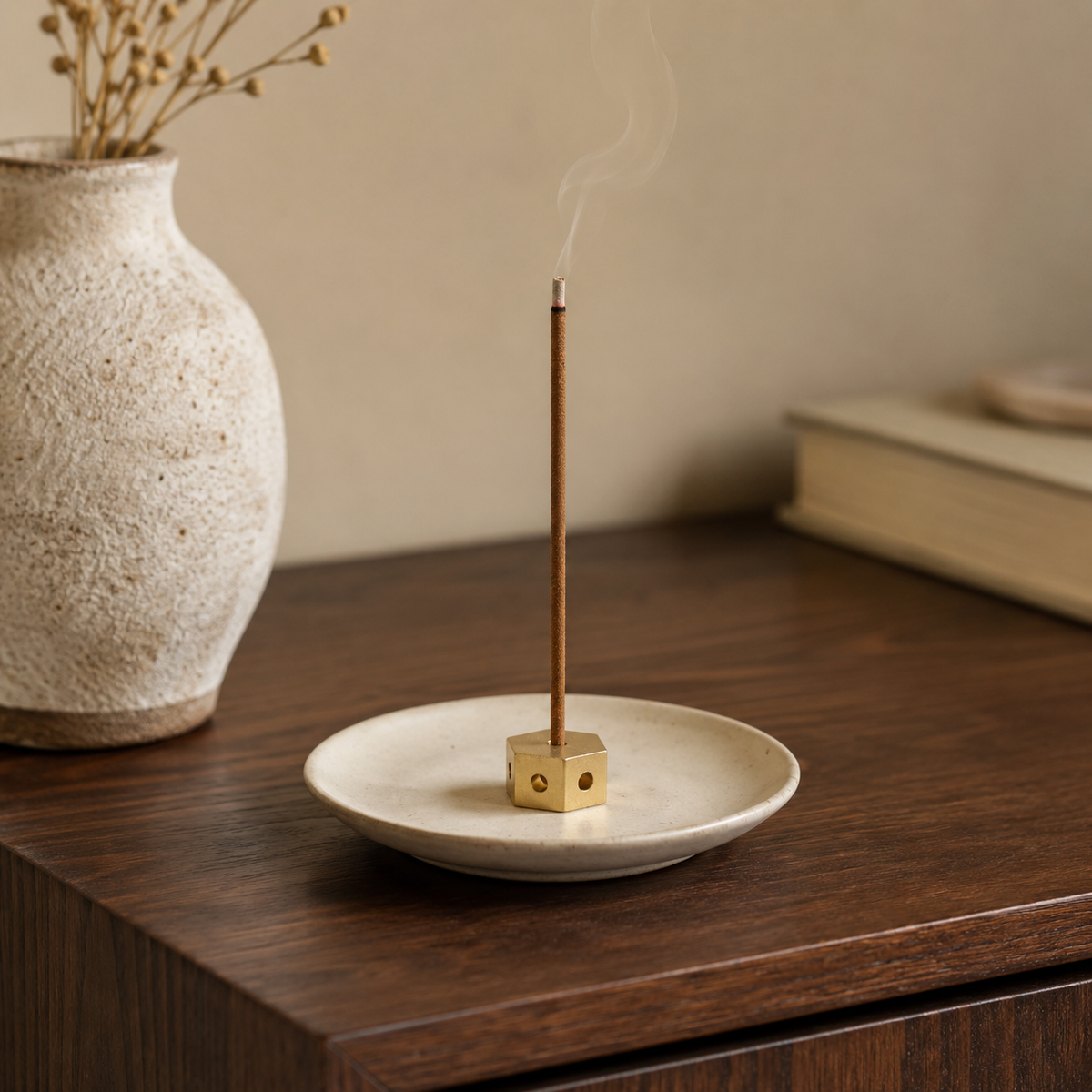 Lhasa Remedy brass hexagonal incense holder with burning Tibetan incense stick on ceramic plate