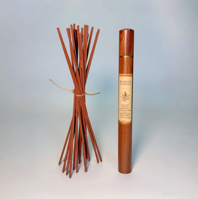 Lhasa Remedy’s Buddha’s Mandala Tibetan incense shown with a bundle of handcrafted incense sticks and the wooden storage tube.