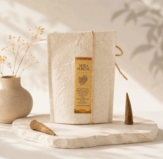 Lhasa Remedy Sera Serene Tibetan incense handmade paper packet on stone slab with two cones and dried flowers