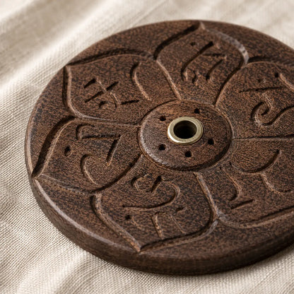 Lhasa Remedy wooden round mandala incense holder held in hand showing size with Tibetan incense stick beside it