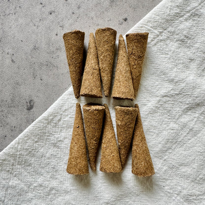 Top-down view of Lucky Zaki Tibetan incense cones arranged neatly on a neutral background, representing abundance, joy, and uplifting energy for mindful rituals.