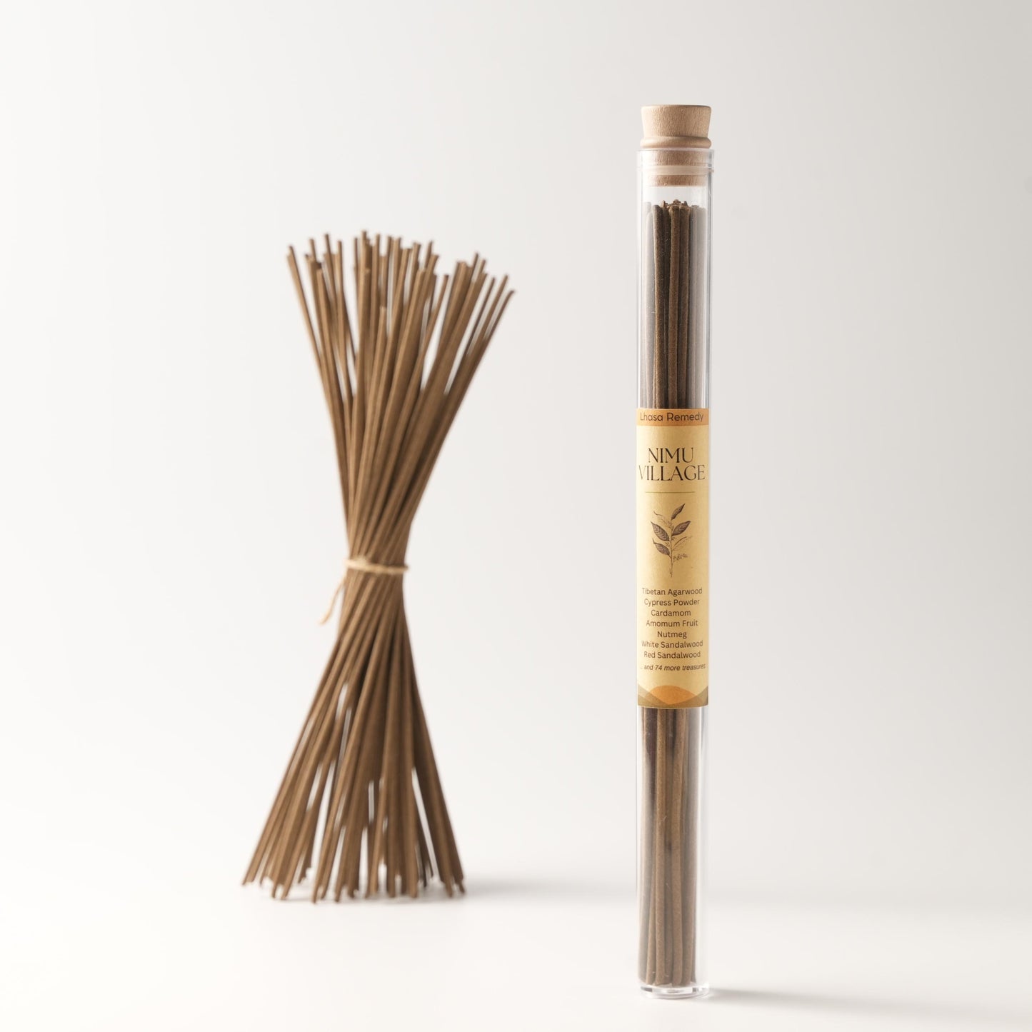 A bundle of Nimu Village Tibetan incense sticks tied together, placed next to a transparent tube packaging labeled “Nimu Village” on a clean white background.