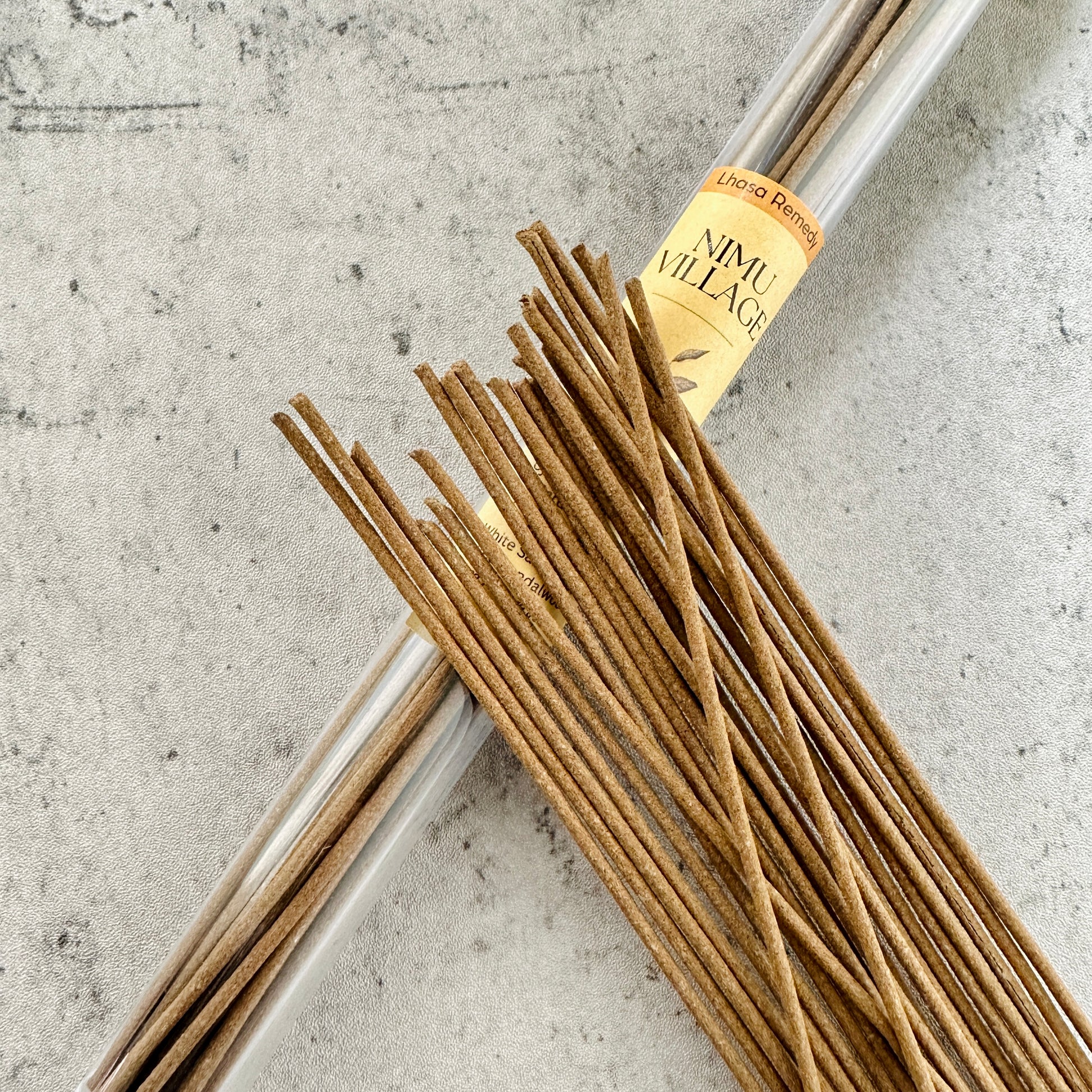 Nimu Village Tibetan incense sticks from Lhasa Remedy displayed spilling from a clear tube, symbolizing sacred heritage and timeless ritual from the heart of Tibet.