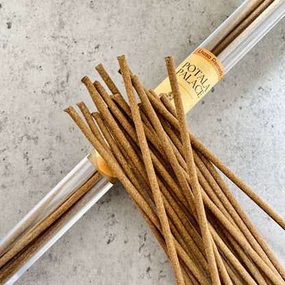 Potala Palace incense sticks from Lhasa Remedy arranged beside a clear tube, inspired by the regal essence and ancient wisdom of Tibetan royalty.