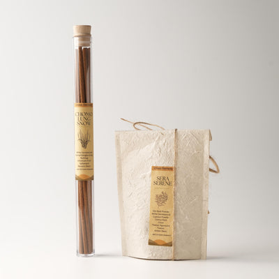Lhasa Remedy’s Wind Horse bundle featuring Chomolung Snow stick incense in a glass tube and Sera Serene cone incense in a handmade paper pouch, both labeled with their traditional Chinese medicine ingredients.